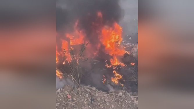 深圳一室外草地着火引燃汽车